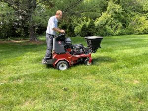 Big green lawn aeration by lawn doctor team through machine in Sandwich