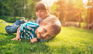 children playing and laughing on grass that had Spring Lawn Care in Little Rock